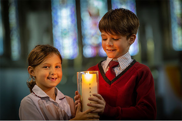 Glebe St James students holding a candle